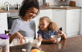 mother and daughter eating alone after divorce and separation in Maine