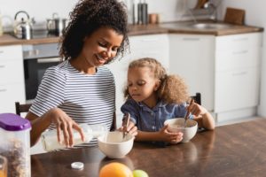 mother and daughter eating alone after divorce